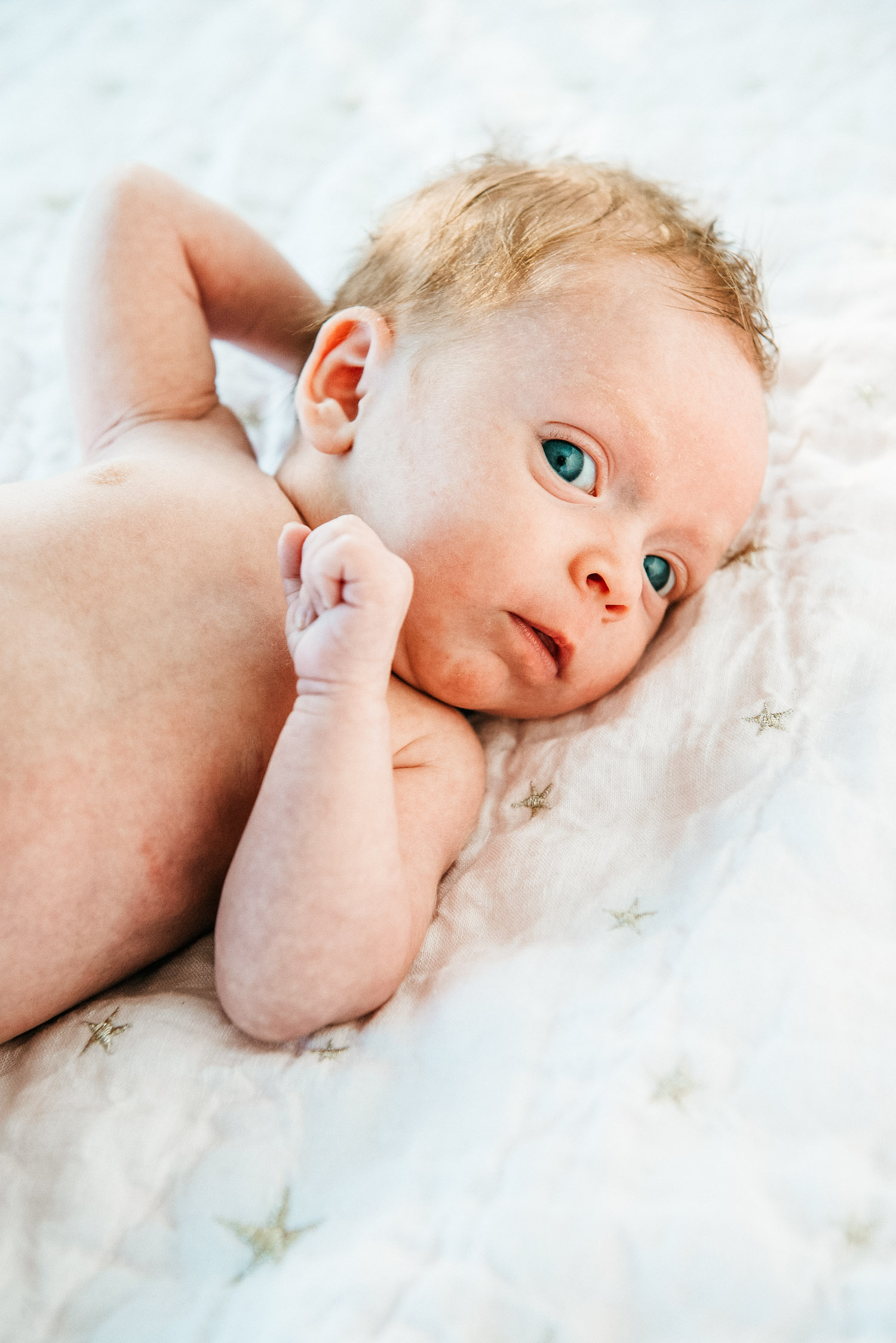 Beautiful newborn baby with eyes open during NYC weekday photography session"